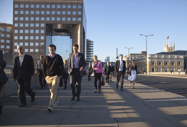 England, London, Early morning commuters crossing London Bridge towards the City Financial district