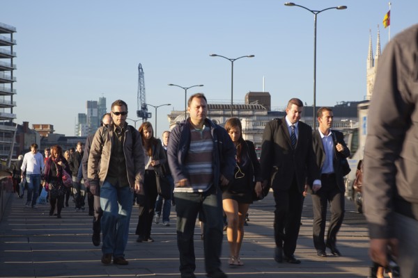 England, London, Early morning commuters crossing London Bridge towards the City Financial district