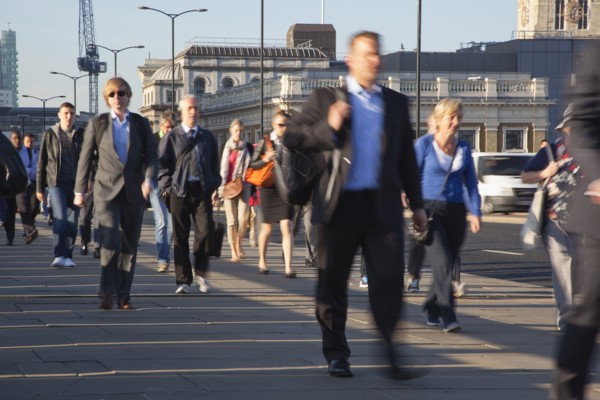 England, London, Early morning commuters crossing London Bridge towards the City Financial district