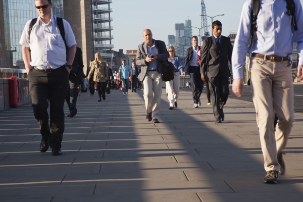 England, London, Early morning commuters crossing London Bridge towards the City Financial district