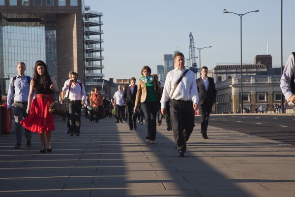 England, London, Early morning commuters crossing London Bridge towards the City Financial district