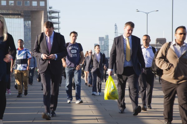 England, London, Early morning commuters crossing London Bridge towards the City Financial district