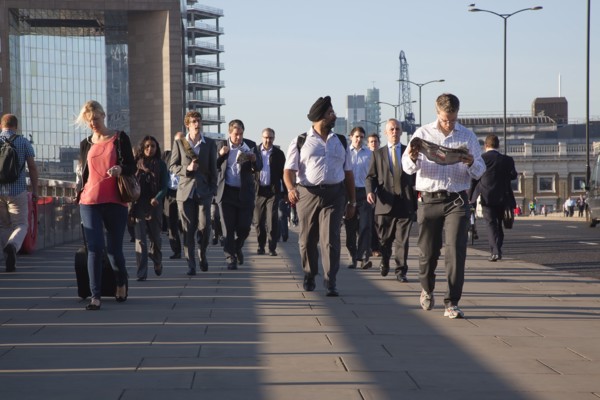 England, London, Early morning commuters crossing London Bridge towards the City Financial district