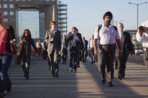 England, London, Early morning commuters crossing London Bridge towards the City Financial district