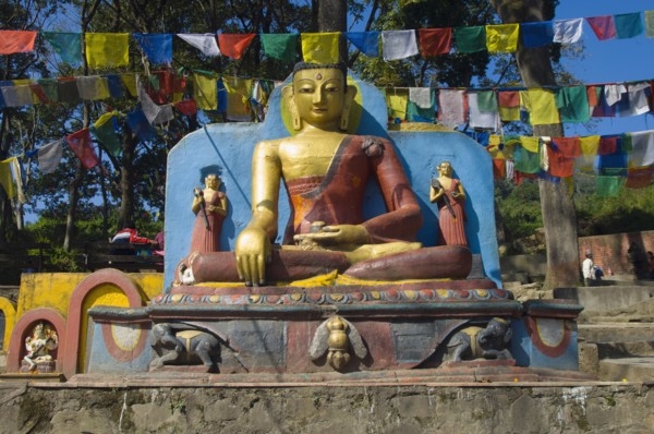 Nepal, Kathmandu, Buddha statue at the foot of the Swayambunath Monkey Temple. 
Photo Nic I Anson