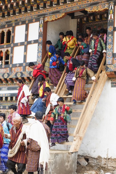 Bhutan, Gangtey Gompa, Tsecchu festival crowds descending temple steps dressed in their best