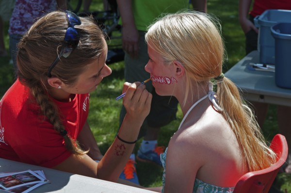 Canada, Alberta, Lethbridge, A bare-shouldered young blonde Canadian girl sits to have the word
