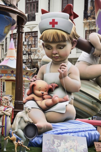 Spain, Valencia Province, Valencia, Papier Mache figure of young girl in nurses outfit with teddy