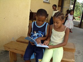 Two children reading together, 2003
