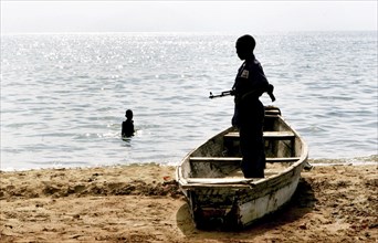 Burundi, A government soldier on a beach of lake Tanganjika near the border of Tanzania. Previous