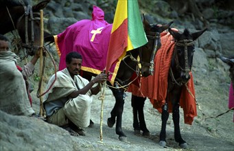 STEED MINDER AT FUNERAL, ;LALIBELA, ETHIOPIA
