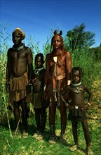 HIMBA FAMILY ON KUNENE RIVER BANK, NAMIBIA