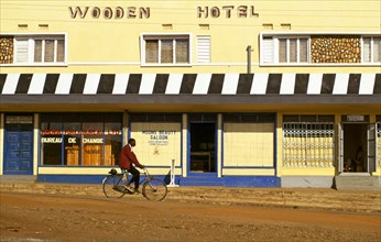CYCLIST IN UGANDAN STREET, UGANDA