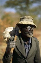 ELDERLY ZIMBABWEAN MAN WITH "DO IT YOURSELF" SPECTACLE REPAIRS, ZIMBABWE