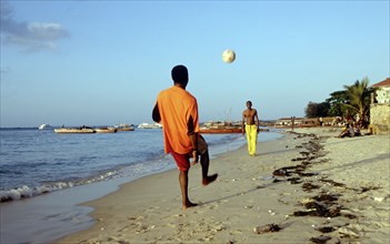 LOCALS KICKING BALL ON BEACH, ZANZIBAR, TANZANIA