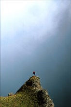 hiker on an outcrop in Mnweni Pass