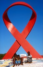 children in front of the AIDS ribbon