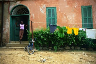 Rokhaxa Samaké runs out of her home - Rue St Germaine, Ile De Gorée, Rep. De Senegal