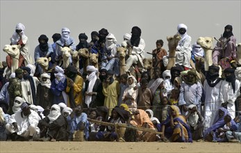 Nomads and animals are seen watching the Wodaabe dance at the Salt Cure festival drawing nomads