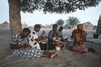 Ladies weaving baskets.