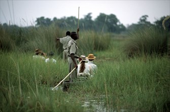 Tourists in Mekoros.Okavango Delta