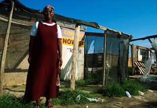 A member of the Silahliwe community outside her shack.