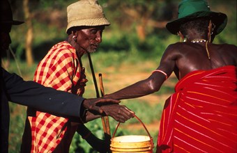 Samburu elders lend one another a helping hand