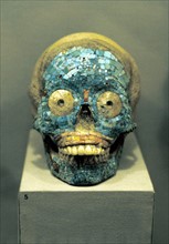 Skull covered in turquoise mosaic