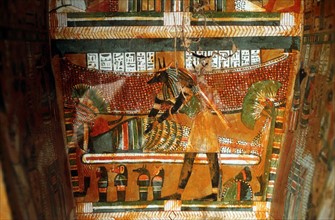 Jackal-headed god Anubis receiving dead king or noble