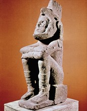 Aztec sculpture of seated male figure