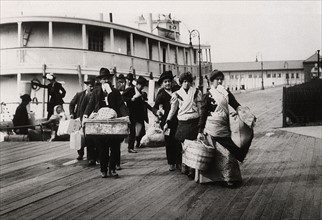 Emigrants to US landing at Ellis Island circa 1900