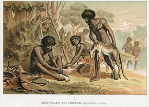 Australian natives preparing meal from animal they have hunted