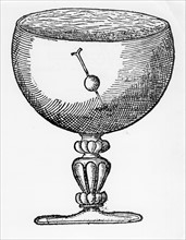 A magnetized needle pushed through a ball of cork, and floating submerged in a goblet of water, shows dip and the direction of the magnetic pole