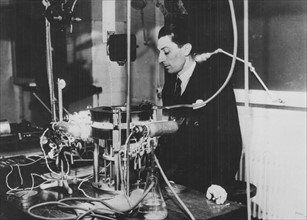 (Jean) Frederick JOLIOT-CURIE (1900-1958), French physicist, in about 1930. The apparatus is a