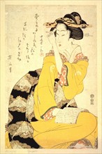 A Geisha reading a book