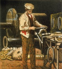 The Engineer using a file on an engine part held in a vise