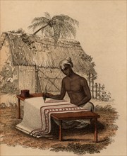 Artisan indien peignant à la main un tissu de coton