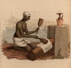 India : beating cotton cloth with wooden mallets