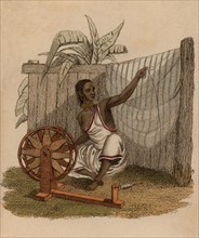 Indian woman spinning cotton