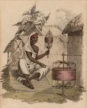Femme indienne en train de former une pelote de fil de soie