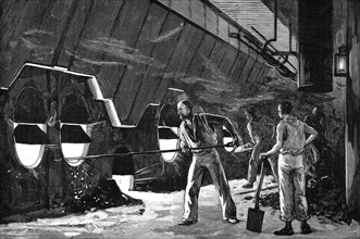Stokers at work in the heat of the boiler room of a transatlantic liner