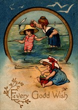 Children paddling and playing on the sands