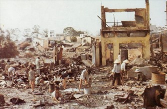 Civilians sort through the ruins of their homes in Cholon