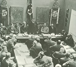 Hitler in Munich adressing a meeting of the NSDAP in 1925. Third to the left of Hitler is Alfred
