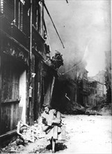 In a German town in 1945 a woman flees after explosions rock the buildings