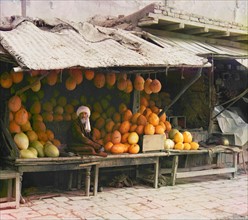 Melon seller in a fruit stall at a market in Samarkand