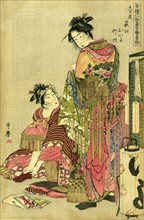 Two geishas dressing for a festival