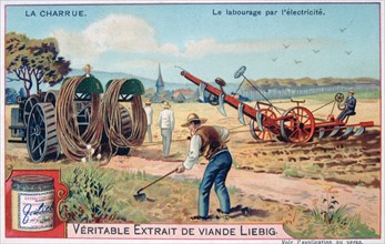 Electric plough being dragged across a field