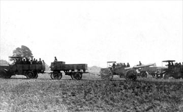 French military motorised vehicles carrying gun crews and a hauling field artillery