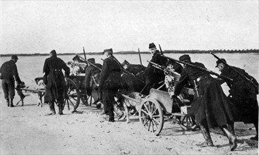 Belgian machine gunners transporting their weapons on carts pulled by dogs